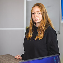 Trainee stands in front of the board