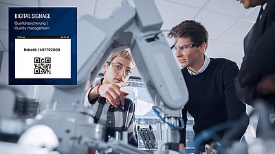 Technicians inspect a robotic arm in a lab with QR-code signage for quality management.