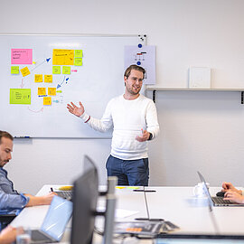 Trainee stands in front of a whiteboard
