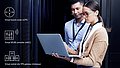 Two employees look at a laptop, icons of the vCPEs, vWLCs and vGateways are shown next to it